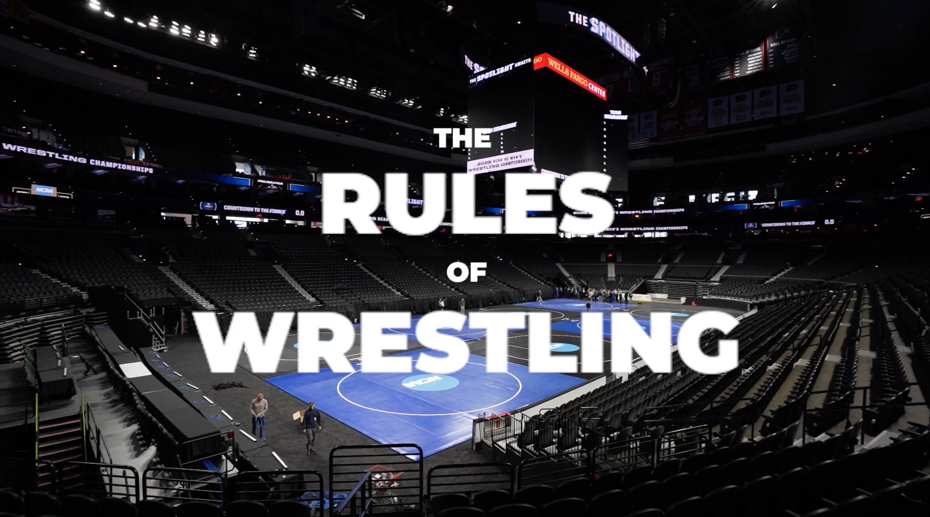 NCAA Championship wrestling arena with ‘The Rules of Wrestling’ graphic, representing an introduction to wrestling scoring and match rules.