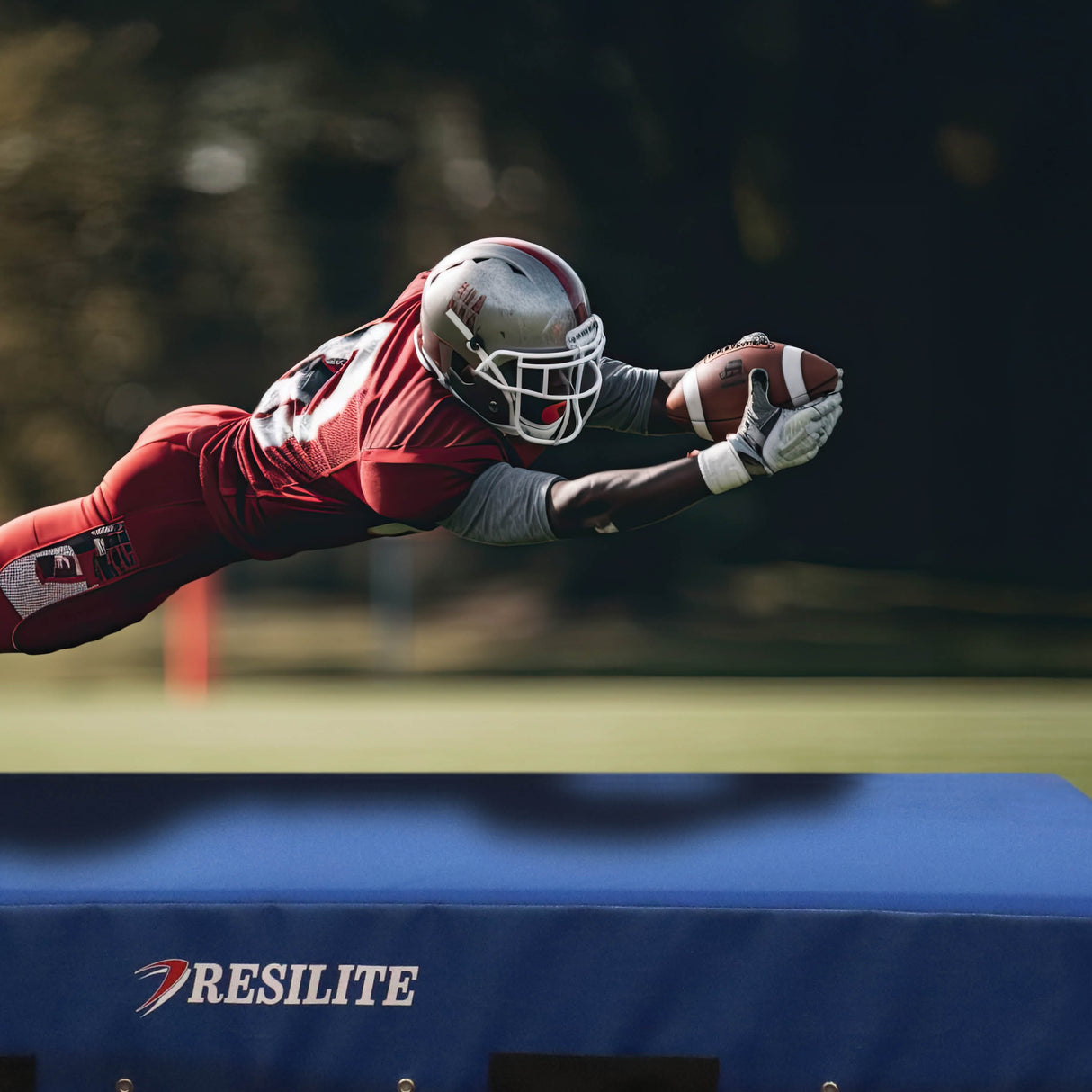 football player landing on crash mat during tackling or conditioning drill