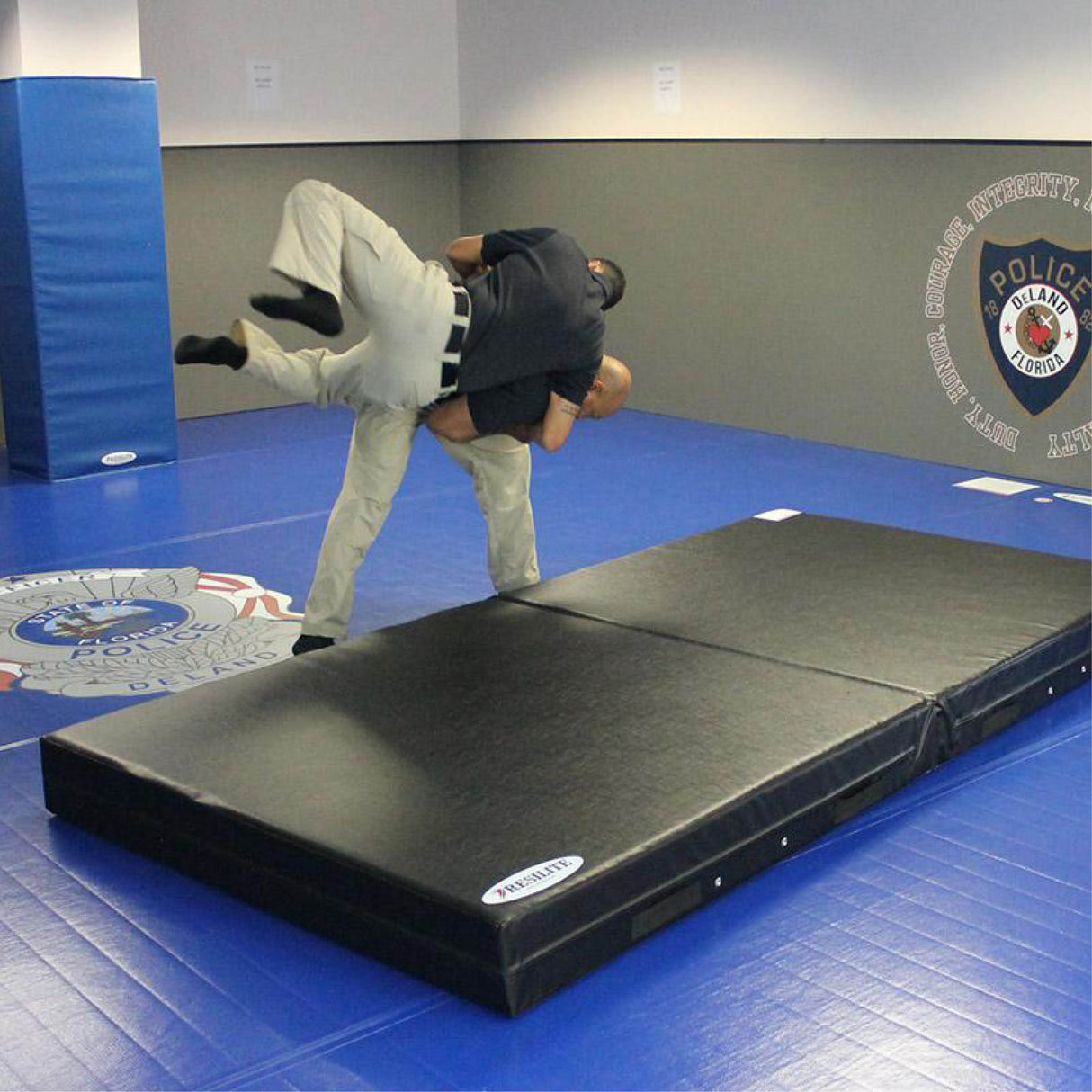 law enforcement officers using crash mat for defensive tactics training drills
