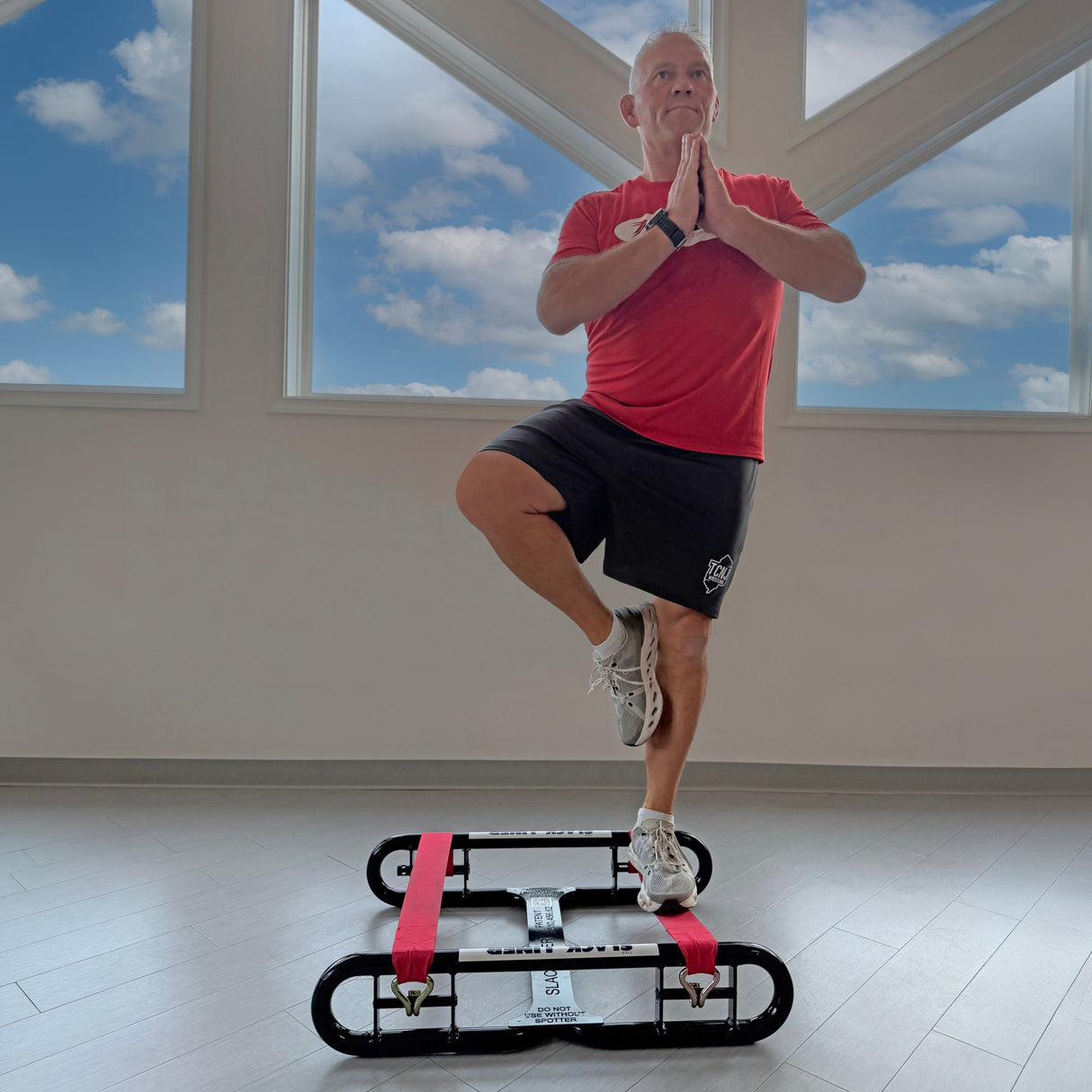 Man doing a yoga pose on The Slack Liner for coordination and core stability