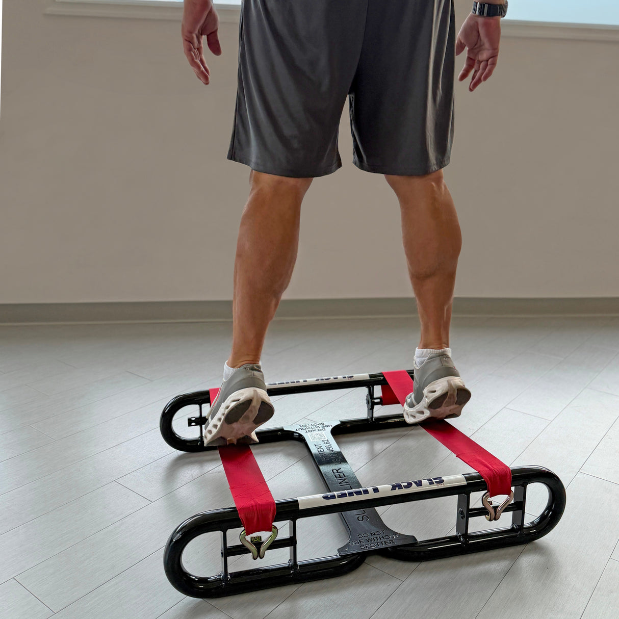 Man doing calf raises on The Slack Liner for coordination and lower body stability
