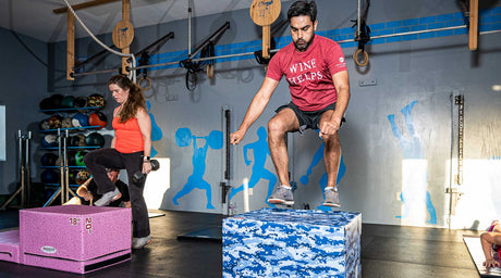 Athletes performing plyometric box jumps and step-up exercises using Resilite 6-in-1 Plyo Boxes during functional fitness training