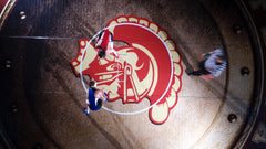 Basketball game in progress with players on a court featuring a large logo.-Resilite