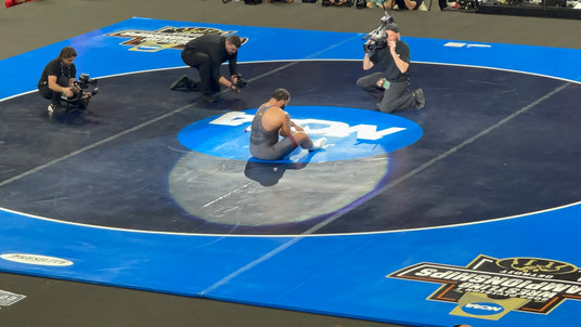 Gable taking his shoes off on the mat. 